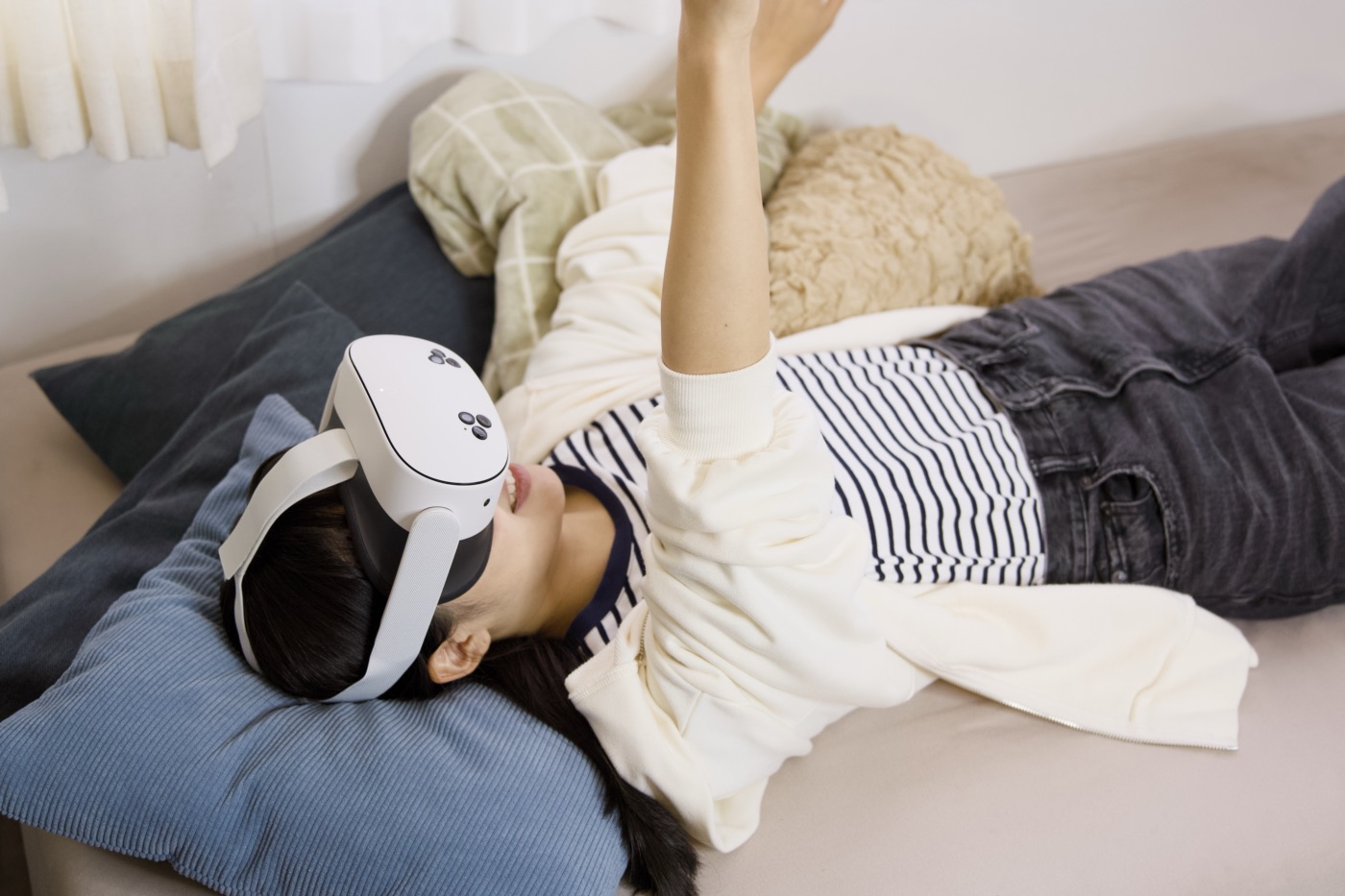 寝転びながらMeta Quest 3Sで遊ぶ女性