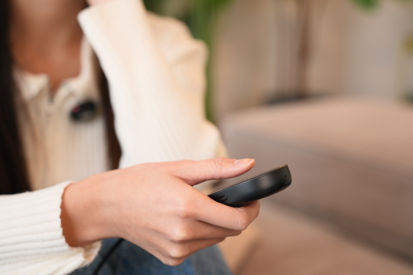 女性がソファに座り、INAIR Podを操作する様子