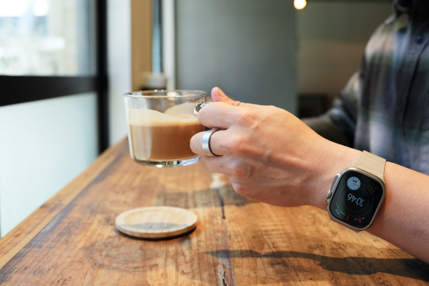 Smart Recovery Ringを装着しながらカフェラテのカップを掴む筆者